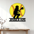 Softball catcher wall sign displayed on a white paneled wall above a console table