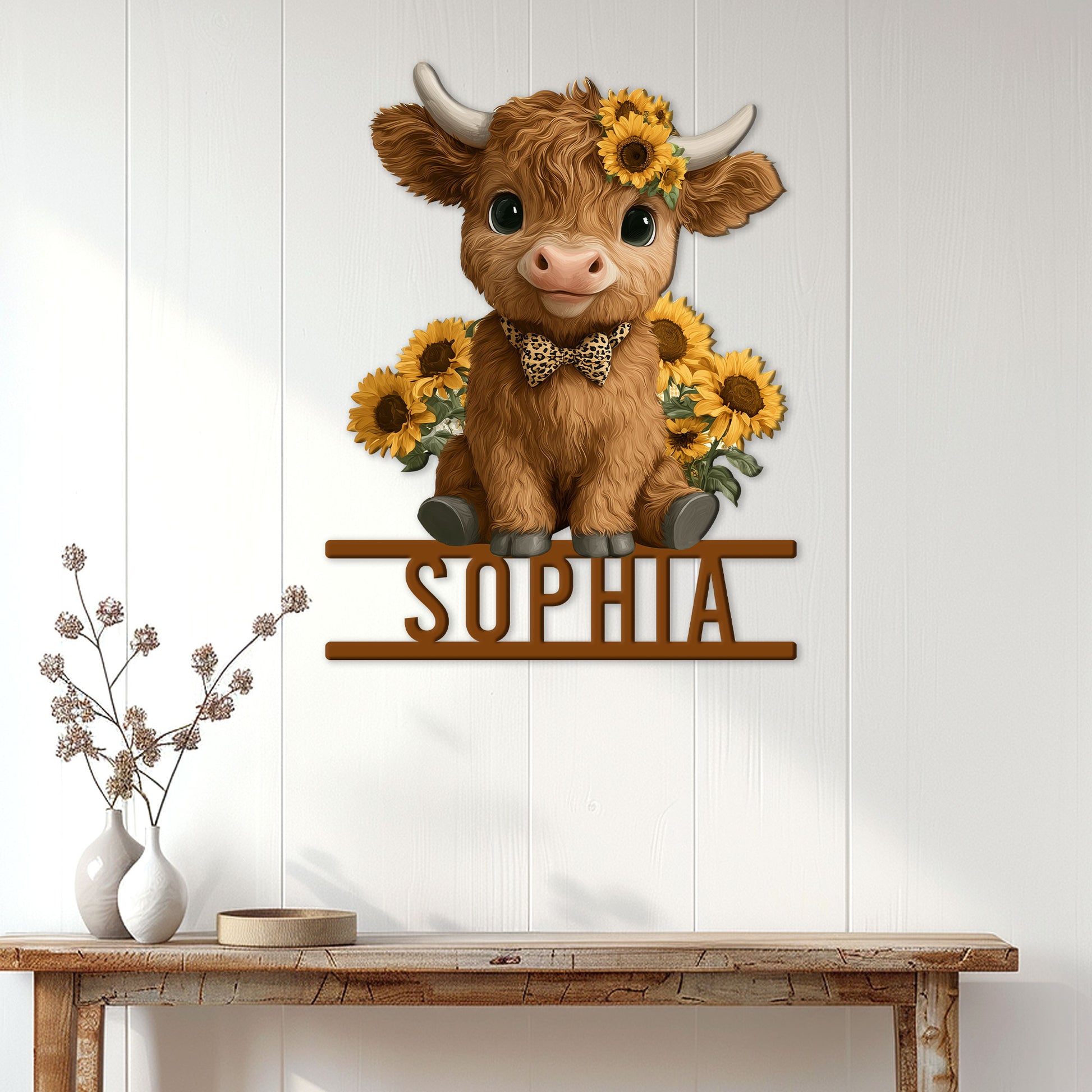 Highland cow wall sign displayed on a white-paneled entryway above a rustic console table