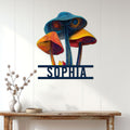 Colorful mushroom wall sign displayed on a white paneled wall above a rustic console table