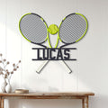 Tennis racket metal wall sign displayed on a light wood-paneled wall in a home interior