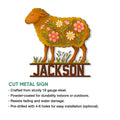 Cut metal sheep sign with a flower-covered body, grass detail, and custom design for indoor or outdoor decor