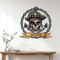 Pirate skull and anchor metal sign displayed as nautical wall decor above a rustic console table