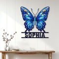 Blue butterfly wall sign displayed above a console table in a bright, modern home entryway