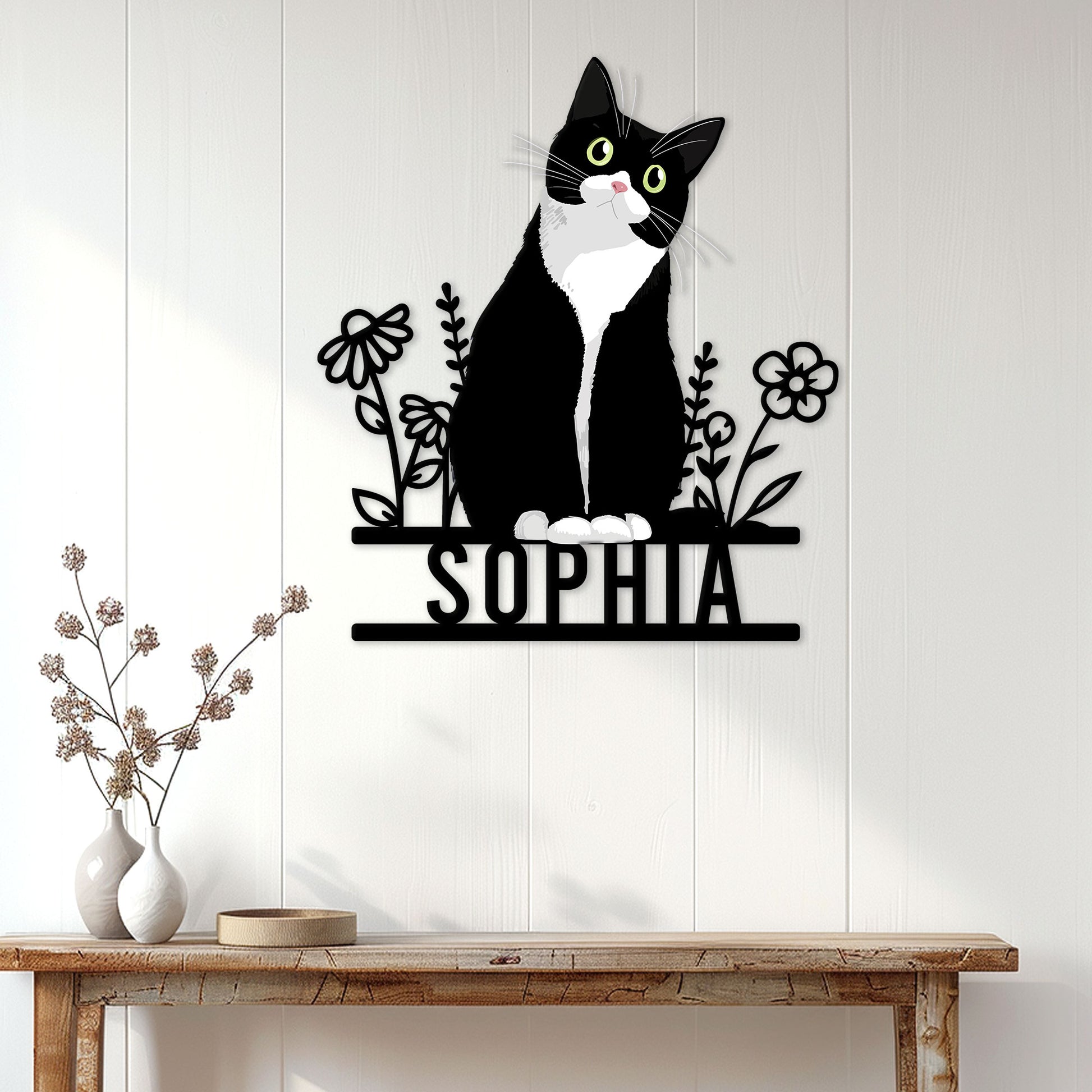 Tuxedo cat wall sign displayed on a light paneled wall above a rustic console table