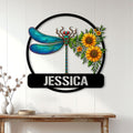 Dragonfly wall sign displayed above a console table, featuring sunflowers and vibrant blue wings
