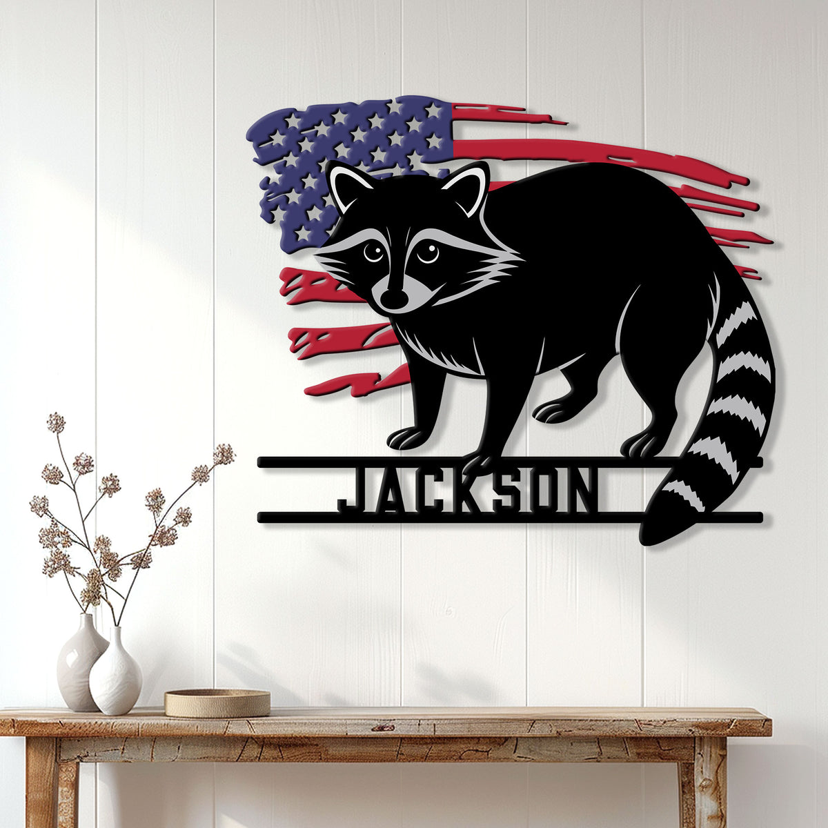 Patriotic raccoon wall sign displayed on a white paneled wall above a console table