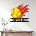 Flaming softball wall sign displayed on a light wood-paneled wall above a console table
