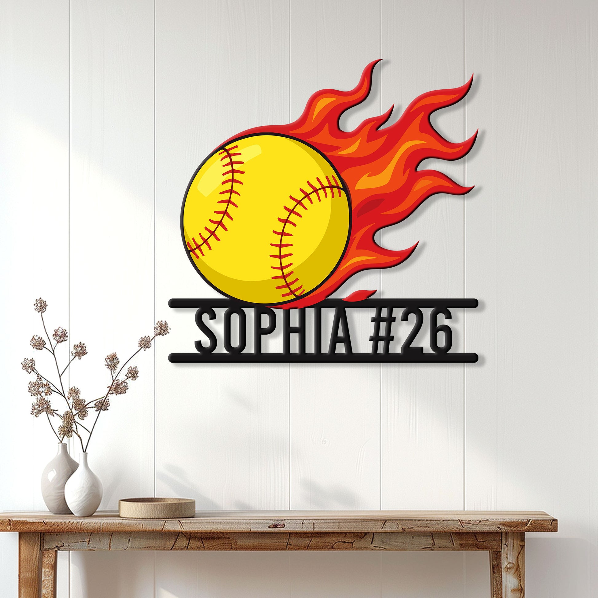 Flaming softball wall sign displayed on a light wood-paneled wall above a console table