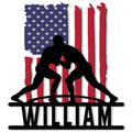 Patriotic wrestling metal sign featuring two grapplers silhouetted against a distressed American flag