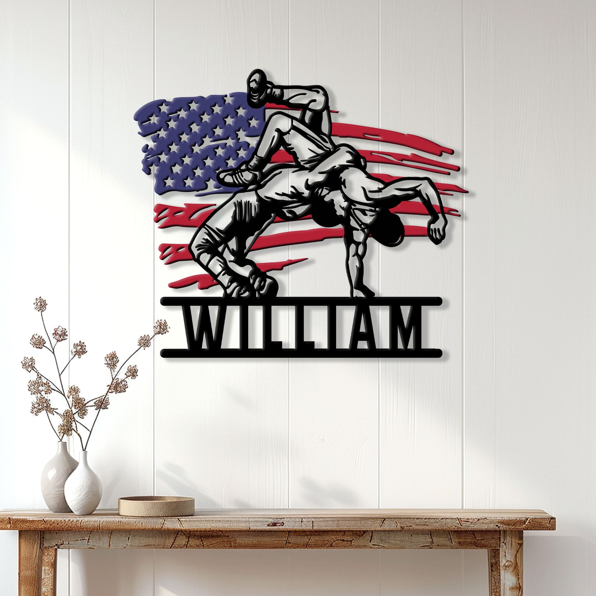 Wrestling wall decor displayed on a white paneled wall, featuring two grapplers over an American flag