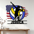 Volleyball player silhouette metal wall sign displayed on a bright paneled wall above a console table