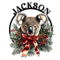 Custom koala metal sign with a festive red bow, evergreen branches, berries, and pinecones