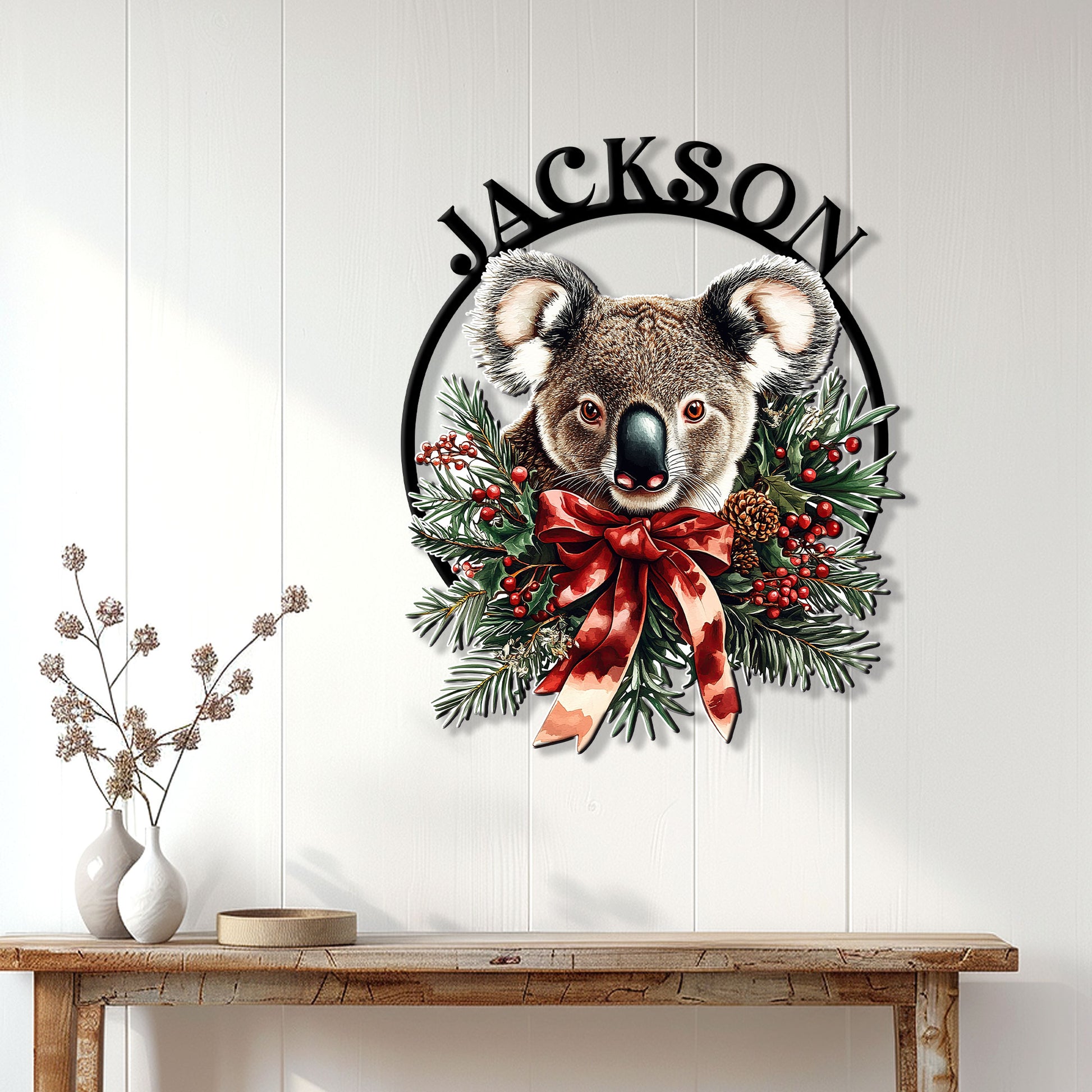 Koala holiday wall decor displayed on a white paneled wall above a wooden console table