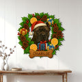 Cane Corso holiday metal sign displayed on a white wall above a wooden console table