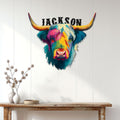 Colorful Highland Cow wall sign displayed above a rustic console table in a bright home entryway