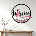 Breast cancer Warrior metal wall sign displayed above a console table in a bright home entryway