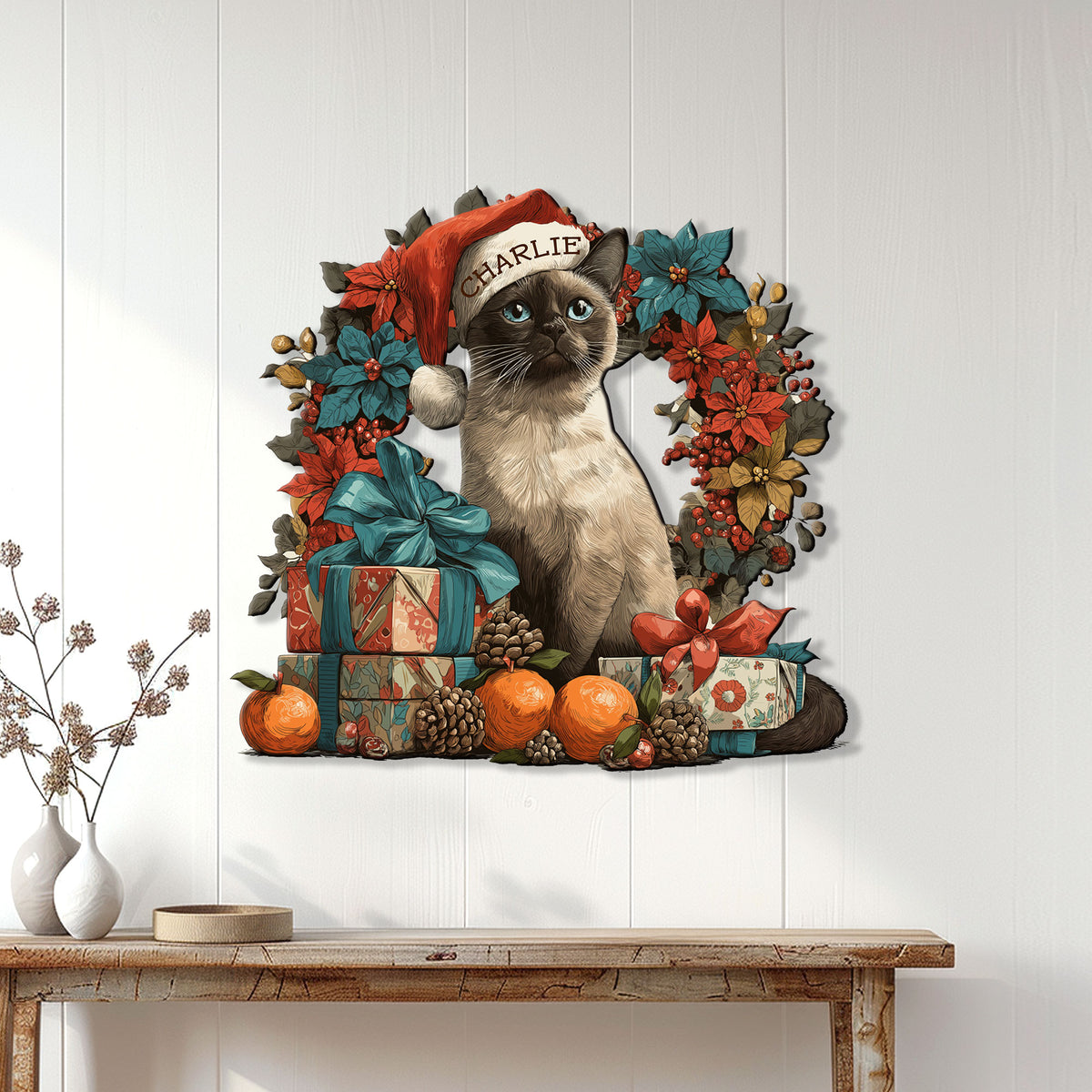Siamese cat Christmas wall decor displayed on a white wood wall above a console table