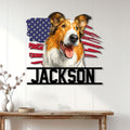Patriotic Rough Collie metal sign displayed as wall decor on a light wood-paneled entryway