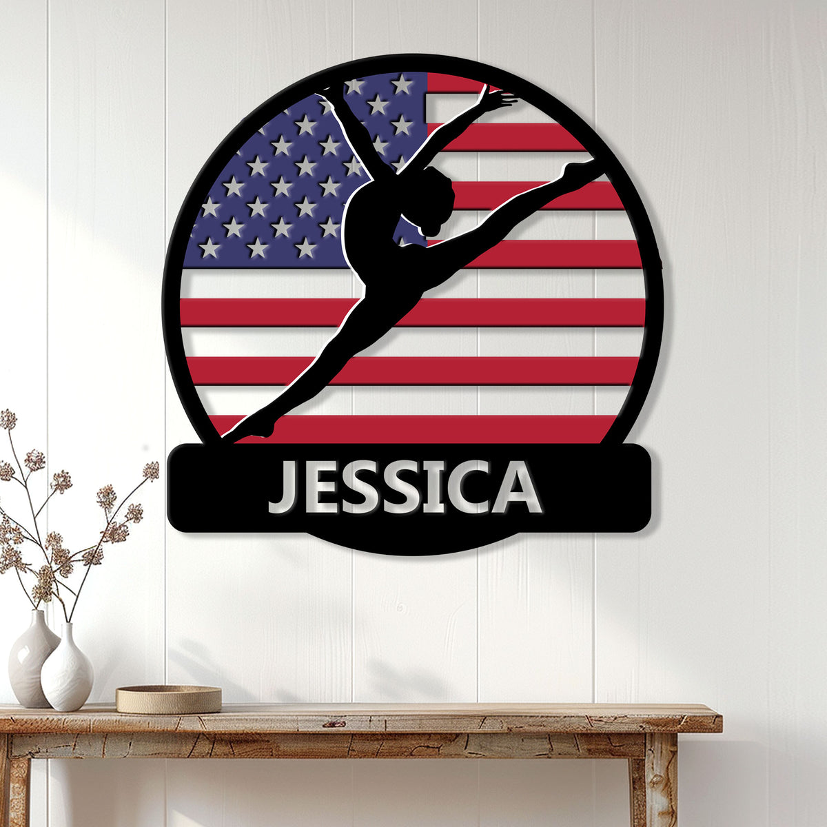 Custom gymnastics wall sign displayed on a white paneled wall with an American flag gymnast design