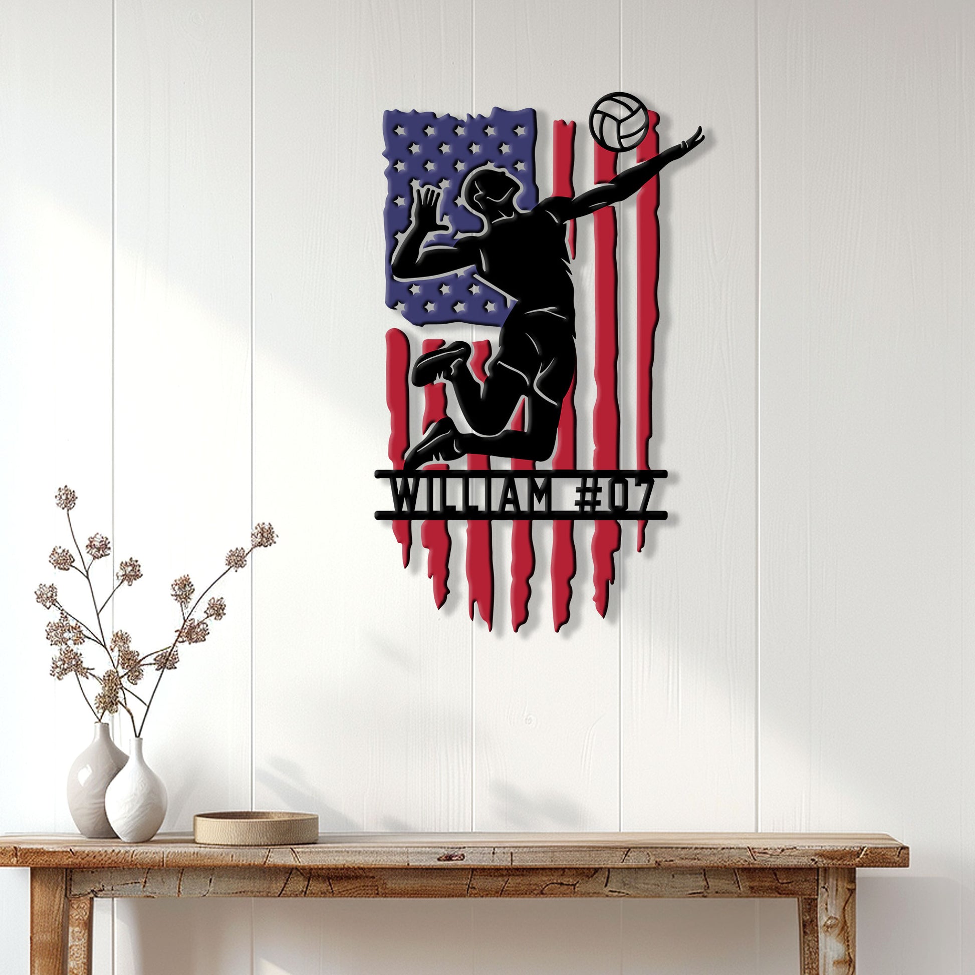 Patriotic volleyball wall decor displayed on a white paneled wall above a wood console table