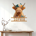 Floral Highland Cow wall sign displayed on a bright farmhouse entryway wall