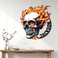 Flaming skull metal wall sign displayed on a light wood-paneled wall above a console table