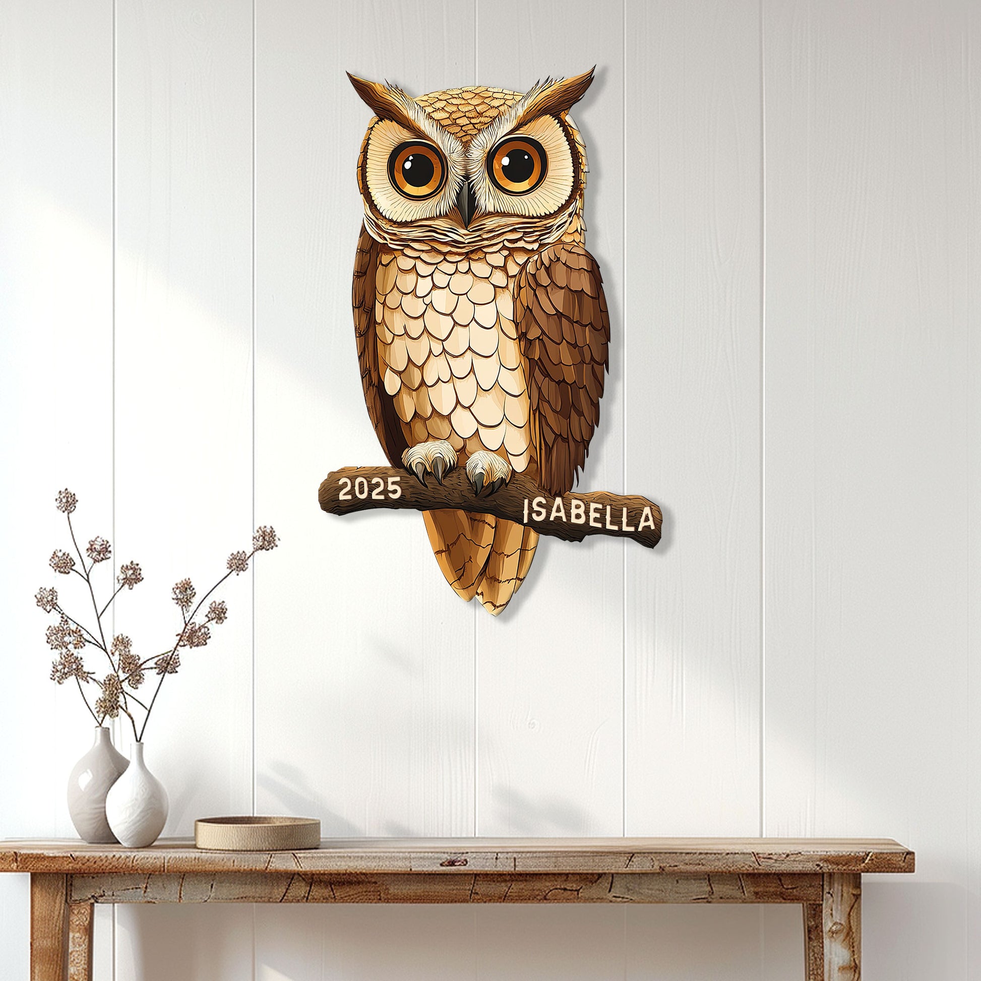 Realistic owl metal wall sign displayed on a light wood-paneled wall above a console table