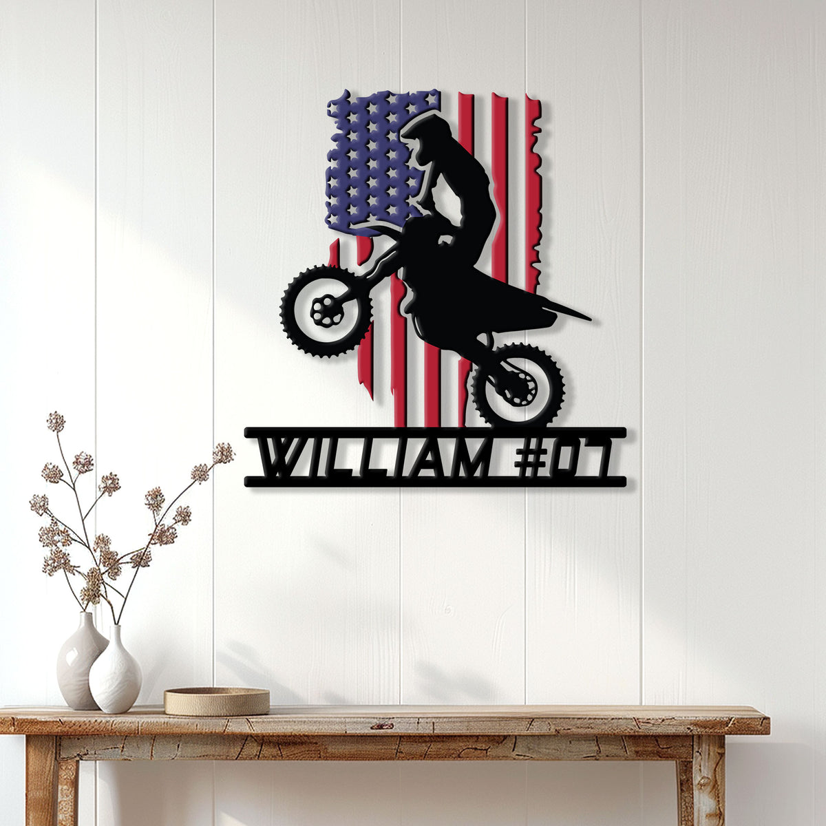 Patriotic motocross metal sign displayed as wall decor above a console table in a bright home
