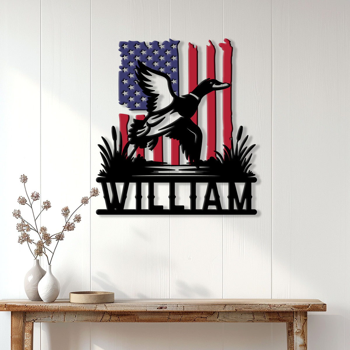 Patriotic duck hunting metal sign displayed on a white paneled wall above a console table