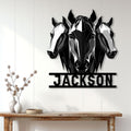 Three-horse metal wall sign styled in a bright modern entryway above a rustic console table