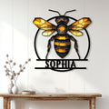 Honey bee wall decor displayed above a console table in a bright home interior with white paneled walls