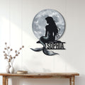 Moonlit mermaid metal sign displayed on a light wood-paneled wall in a home