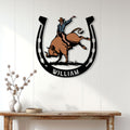 Rodeo wall decor featuring a colorful bull rider horseshoe design in a home entryway