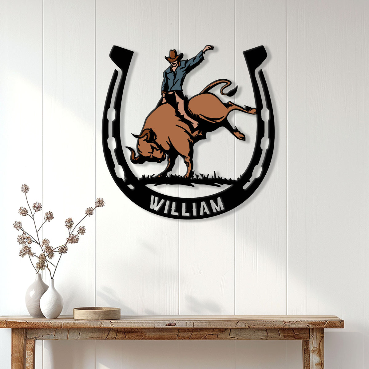 Rodeo wall decor featuring a colorful bull rider horseshoe design in a home entryway