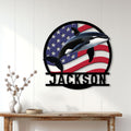 Patriotic orca metal wall sign displayed on a bright wood-paneled living room wall
