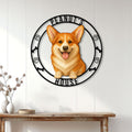 Corgi house sign displayed on a white paneled wall above a wooden entryway table