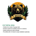 Cut metal bear sign shown with a forest scene, dramatic orange backdrop, and decorative banner