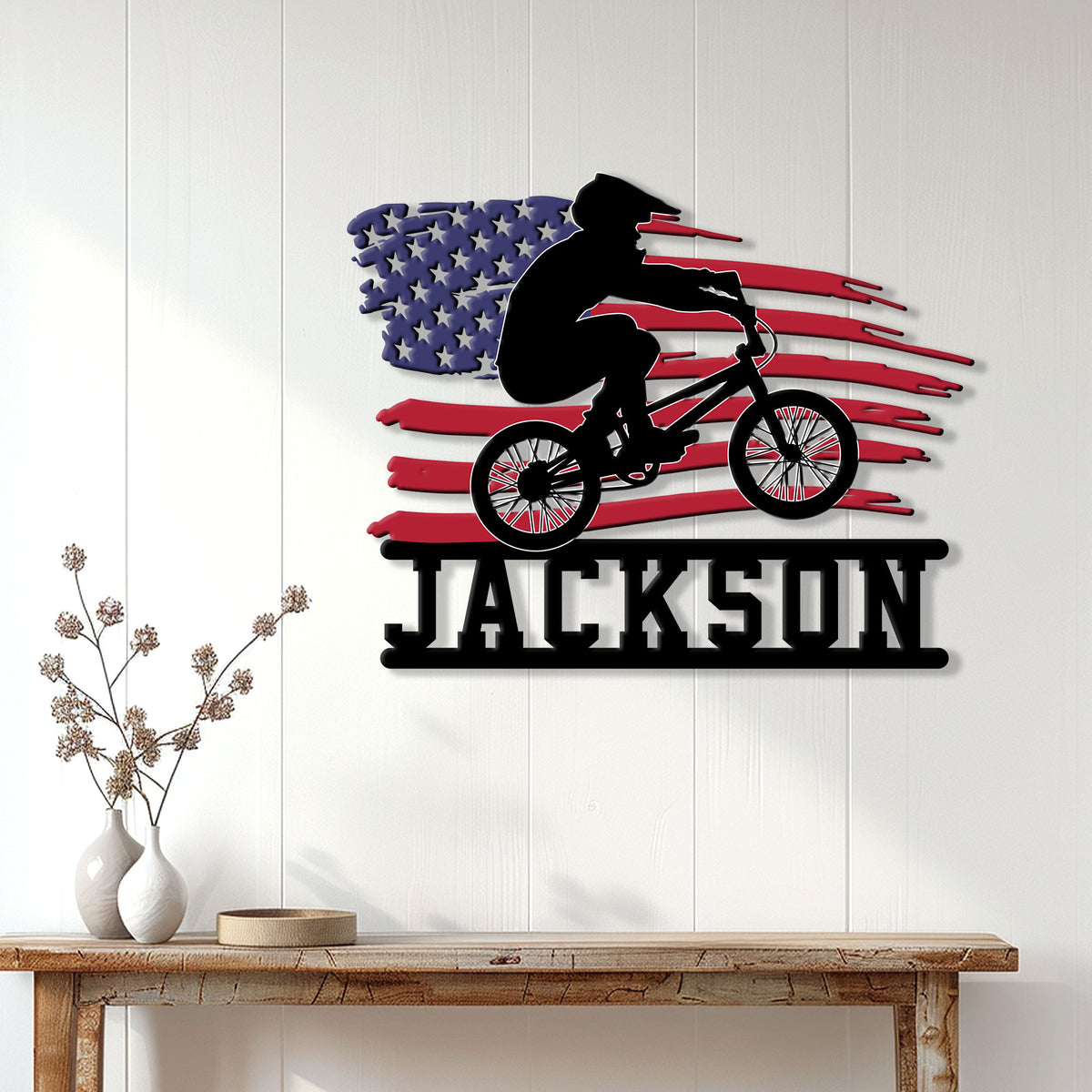 Patriotic BMX wall decor displayed on a white paneled wall above a console table
