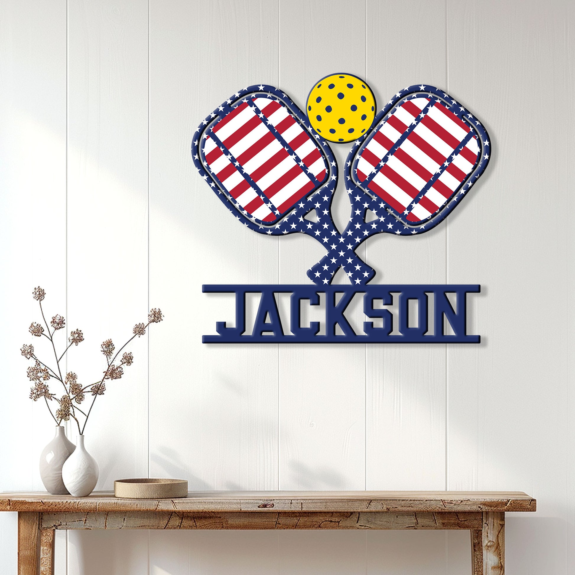 Patriotic pickleball metal sign displayed on a light wall above a console table