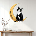 Tuxedo cat wall sign displayed on a white paneled wall above a console table