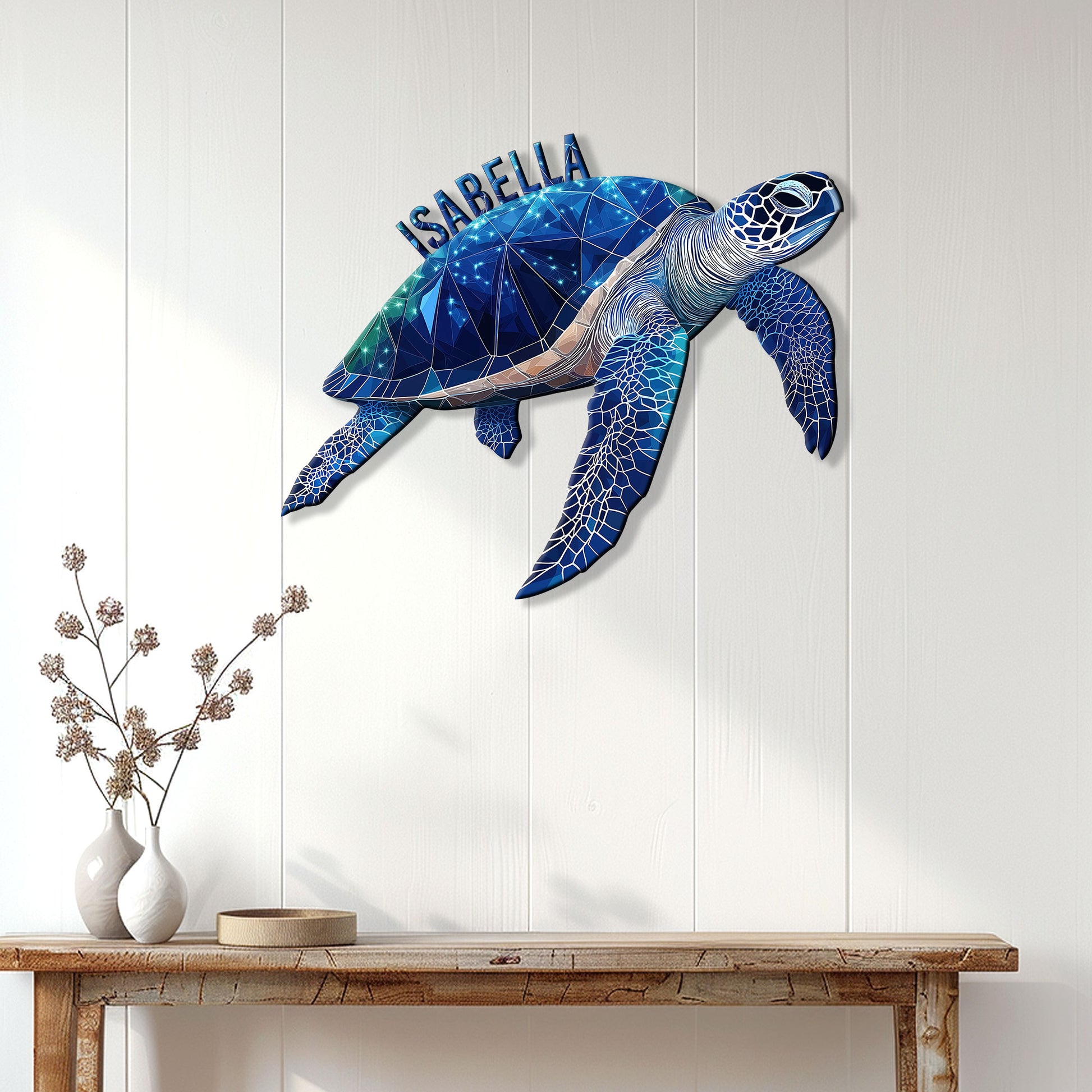 Geometric blue sea turtle wall sign displayed on a light wood-paneled wall above a console table