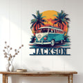 Retro camper van wall sign displayed on a white paneled wall with tropical palms and vibrant sunset artwork