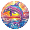 Colorful stained-glass style dolphin leaping over ocean waves at sunset on a round metal sign