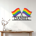 Pride rainbow metal sign displayed on a white paneled wall above a console table