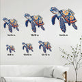 Sea turtle metal wall sign shown in multiple size options above a living room sofa