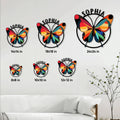 Butterfly metal sign shown in multiple size options above a modern living room sofa