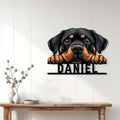 Rottweiler dog metal wall sign displayed on a light wood-paneled entryway above a console table