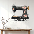 Sewing room wall decor featuring a rose-covered vintage sewing machine sign above a console table