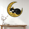 Tuxedo cat metal wall sign featuring a sleeping cat on a golden crescent moon in a bright home setting