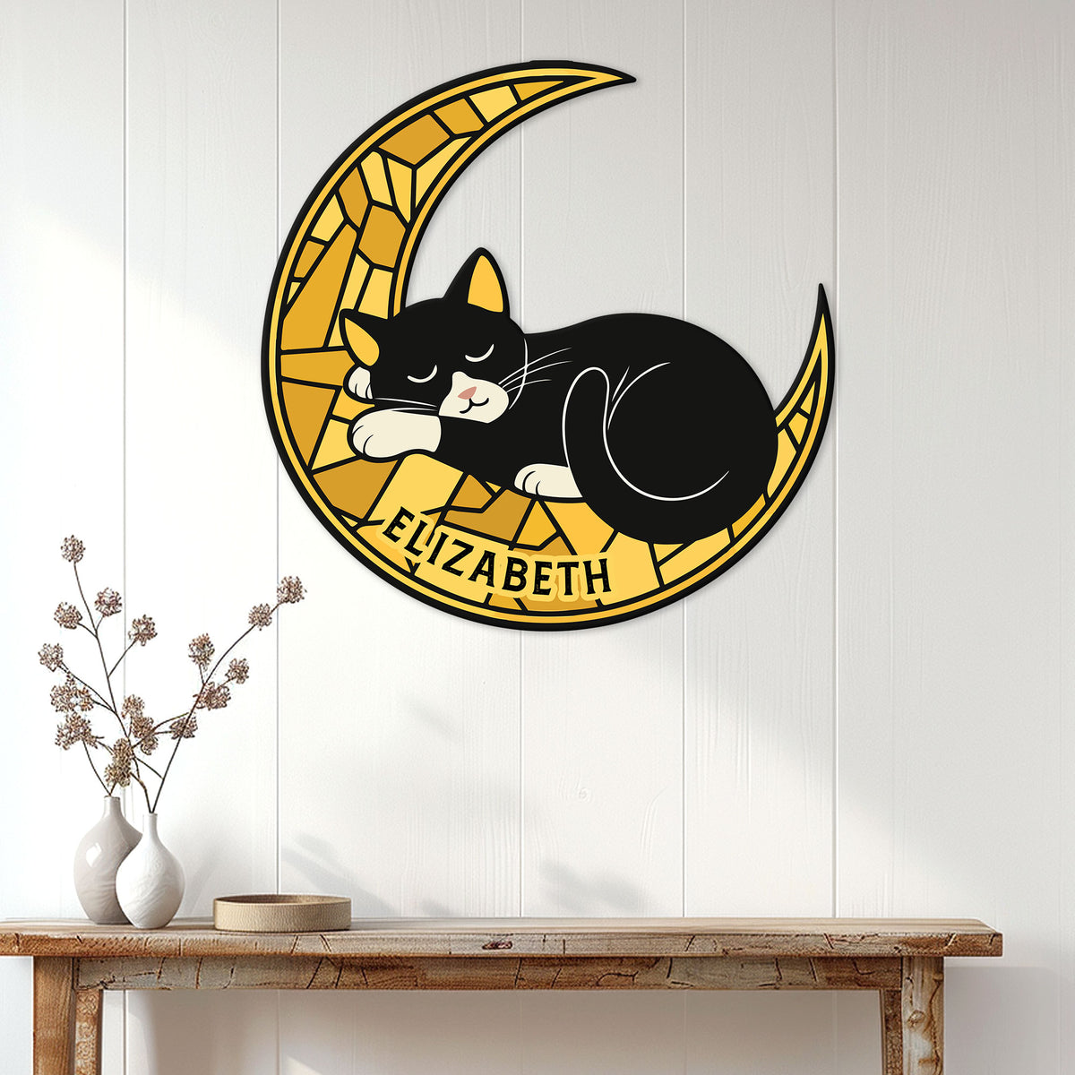 Tuxedo cat metal wall sign featuring a sleeping cat on a golden crescent moon in a bright home setting